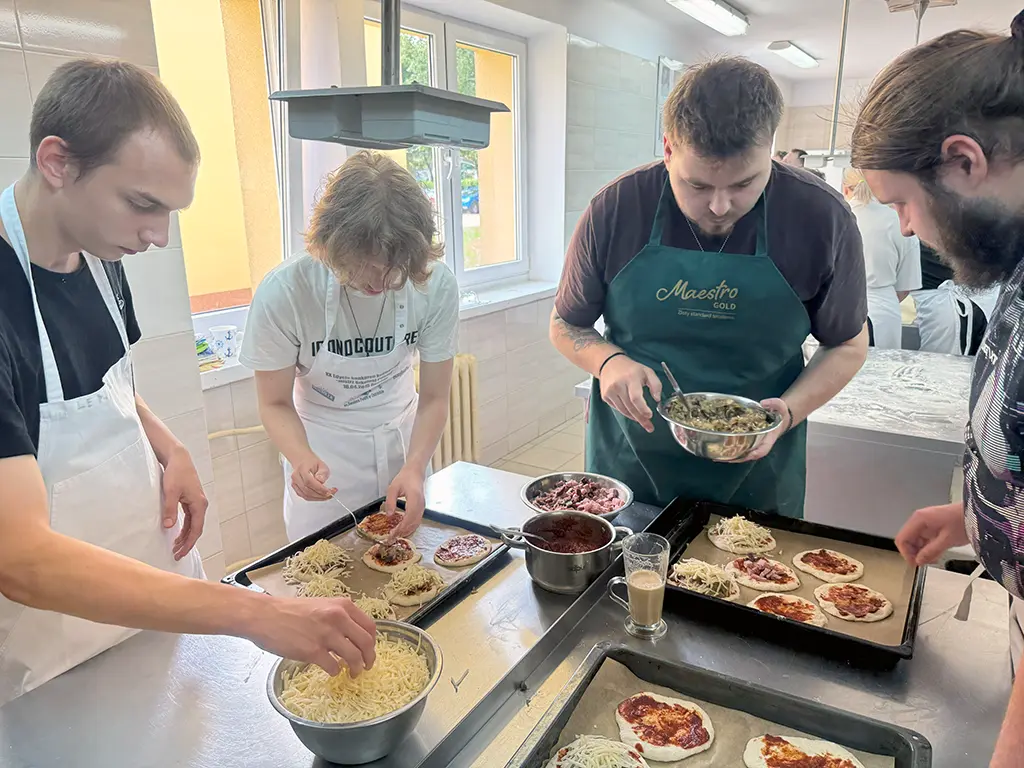 students prepare mini pizzas